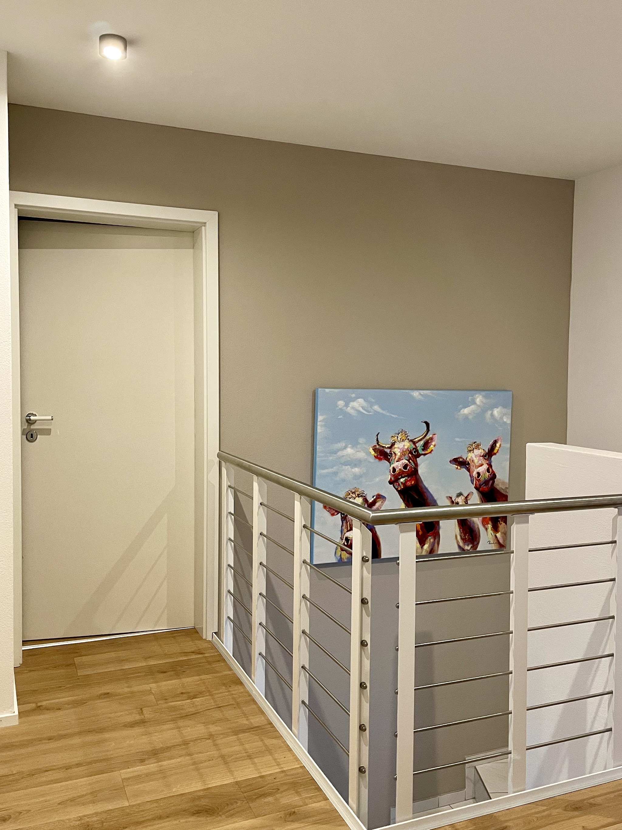 Treppenhaus mit taupefarbener Wand und Bild